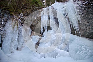 Vysny waterfall in winter in Falcon valley, Slovak Paradise National park, Slovakia