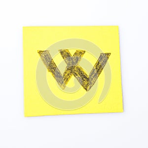 W alphabet letter handwrite on a yellow paper