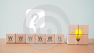 5W1H concept. Business framework and analysis. WHO WHAT WHERE WHEN WHY HOW Questions. Wooden cubes block with 5W1H symbols and photo