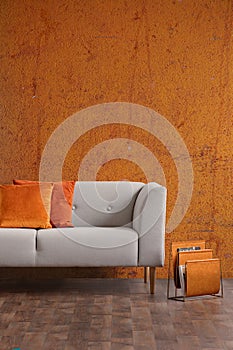 Wabi sabi living room interior with old orange wall and new stylish couch, real photo with copy space photo