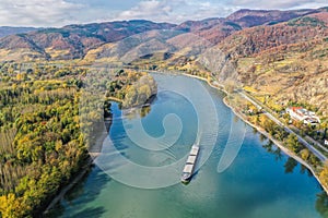Wachau deep valley with ship against autumn forest near Duernstein village in Austria