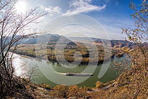 Wachau deep valley with ship against autumn forest near Duernstein village in Austria