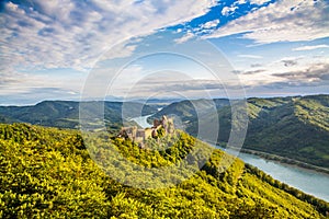 Wachau landscape with castle ruin and Danube river at sunset, Austria photo