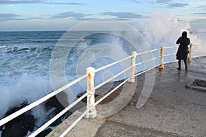 Waching the waves on a pier