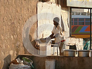 WADI - HALFA, SUDAN - NOVEMBER 19, 2008: Nubian woman washing di