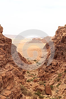Wadi Rum desert panorama seen from canyon with dunes, mountains and sand, Jordan