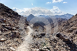 Wadi Shawka narrow hiking trail in rocky limestone Hajar Mountains, United Arab Emirates.