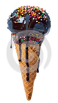 Wafer cone decorated colorful sprinkles and chocolate icing with black scoop of ice cream and glaze with strewn of sprinkles