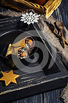 Wafer cups with cottage cheese and chocolate on an old black wooden tray. Selective focus