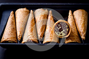 Wafer rolls filled with butter cream and chocolate crisps