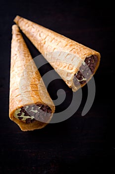Wafer rolls filled with butter cream and chocolate crisps