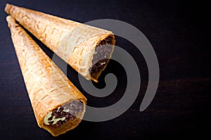 Wafer rolls filled with butter cream and chocolate crisps