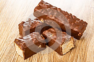 Wafers in chocolate with peanut, halves of wafer on table