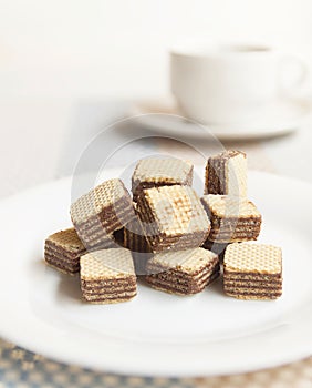 Wafers cubes with chocolate. on White plate