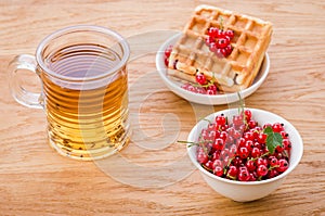 Wafers with red berries and a glass of tea/wafers with red berries and a glass of tea. Selective focus