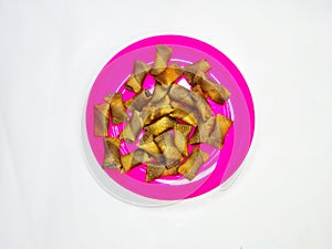 wafers with sweet chocolate filling on a pink plate and white background