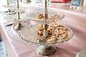 Waffle for Breakfast on the Buffet Table. Miniature Waffles in a Warming Tray with Tongs at a Buffet in a Restaurant.