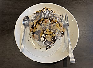 Waffle dish with various topping material on table.