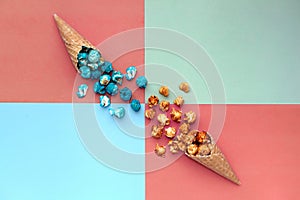 waffle ice cream cone with Popcorn spill-terracota colorful background. fast food snack cornucopia