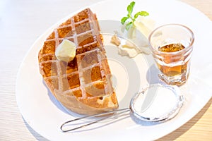 Waffle with maple syrup and butter