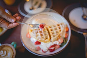 Waffle pancake desert with vanilla ice cream, fresh strawberry and honey syrup