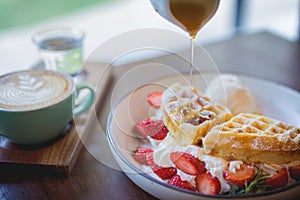 waffle pancake desert with vanilla ice cream, fresh strawberry and honey syrup