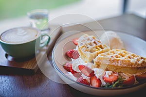 waffle pancake desert with vanilla ice cream, fresh strawberry and honey syrup