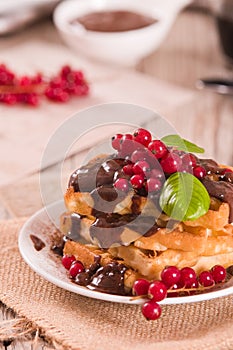 Waffle with red currant and chocolate topping