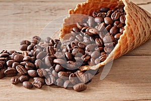 Waffle rolls with cofee beans on wooden background, closeup