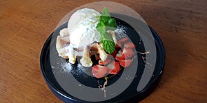 Waffle stroberry with icing sugar and vanilla ice cream