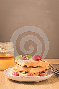 waffles with berries, honey in plate/waffles with berries, honey in plate on a old wooden background with copy space