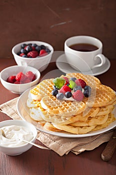 Waffles with creme fraiche and berries for breakfast