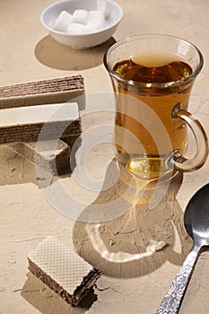 waffles and a cup of tea on a beige table