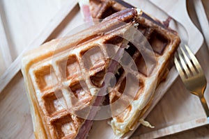 Waffles ham cheese sandwich in wooden plate