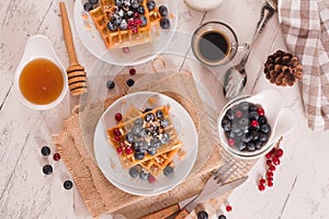 Waffles with red currant and blueberries