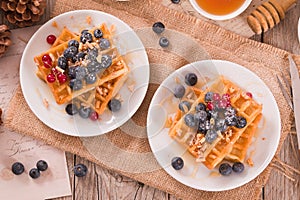 Waffles with red currant and blueberries