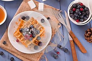 Waffles with red currant and blueberries