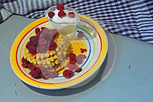 Waffles with sour cream and raspberries