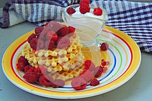 Waffles with sour cream and raspberries