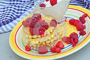 Waffles with sour cream and raspberries