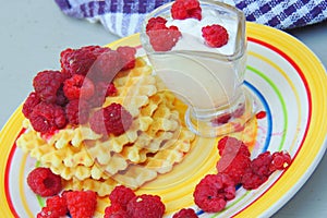 Waffles with sour cream and raspberries
