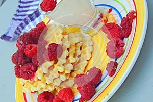 Waffles with sour cream and raspberries