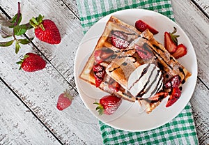 Waffles with strawberries and ice cream