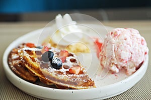 Waffles and Strawberry Ice-cream, Caramel syrup and fresh berry.