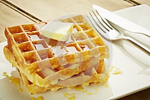 Waffles with syrup on white dish
