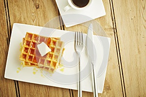 Waffles with syrup on white dish