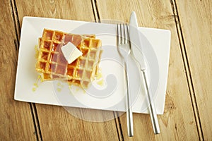 Waffles with syrup on white dish