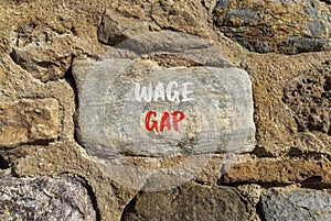 Wage gap symbol. Concept words Wage gap on beautiful stone on a beautiful stone wall background. Business, support and wage gap