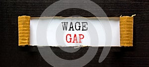 Wage gap symbol. Concept words Wage gap on beautiful white paper on a beautiful black background. Business, support and wage gap