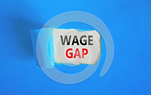Wage gap symbol. Concept words Wage gap on beautiful white paper on a beautiful blue background. Business, support and wage gap